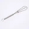 A silver whisk with a coiled spring handle is shown against a white background. Produktbild-Vorschau