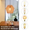 A hanging lamp with a rattan shade is shown above a wooden table with a teapot and cup. To the right, there are four different light bulbs displayed in circles. Produktbild-Vorschau
