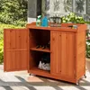 A wooden storage cabinet with doors and shelves, placed outdoors on a patio. Náhled obrázku produktu