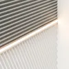 A close-up view of two textured wall panels meeting at an angle, with a strip of LED lighting between them. Náhľad obrázku produktu