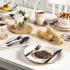 A table setting with cutlery, plates, cups, and food, suggesting a meal or dining experience. Produktbild-Vorschau