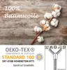 A close-up of cotton bolls on a wooden background, with OEKO-TEX certification details and laundry symbols. Produktbild-Vorschau