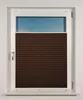 A close-up view of a brown pleated blind covering the lower part of a window. Produktbild-Vorschau