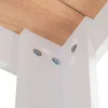 A close-up view of the underside of a wooden table, showing the connection points between the tabletop and the white support structure. Produktbild-Vorschau