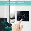 A hand is shown touching a smart thermostat mounted on a wall, with a chair and window in the background. Produktbild-Vorschau