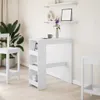 A white bar table with shelves and two white bar stools in a room with a plant and shelves on the wall. Produktbild-Vorschau