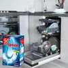 A box of dishwasher salt is placed in front of an open dishwasher filled with dishes. Podgląd zdjęcia produktu