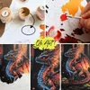 A collage of images showing a paint-by-numbers kit, including paints, canvas, and a finished dragon painting. Produktbild-Vorschau