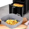 A gray silicone air fryer liner with french fries is shown in front of a black air fryer also containing french fries. Náhľad obrázku produktu