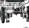 A close-up view of the underside of an electric wheelchair, focusing on the motors and wheels. Náhľad obrázku produktu