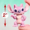 A small pink figurine of a character, possibly from a Disney franchise, is shown close-up. A red arrow and a circle with '2"' indicate its size. Produktbild-Vorschau
