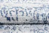A close-up view of a folded rug with a distressed blue and white pattern. Produktbild-Vorschau