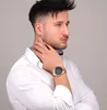 A man wearing a white shirt and a gold watch. Produktbild-Vorschau