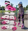 A young girl wearing protective gear and inline skates stands in a park setting, with various inline skate components displayed in the foreground. Náhľad obrázku produktu