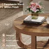 A close-up of a round coffee table with a rustic brown finish, featuring a vase of flowers and books on top. Text overlays highlight product features. Anteprima dell’immagine prodotto