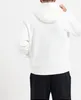 A person wearing a white hoodie and black pants, shown from the back. Produktbild-Vorschau