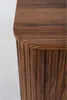 A close-up view of the fluted wood texture and rounded edge of a dark brown cabinet. Podgląd zdjęcia produktu