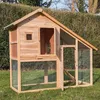 A wooden chicken coop with a wire mesh run is set up on a grassy lawn with a hedge in the background. Produktbild-Vorschau