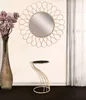 A decorative mirror and a side table are displayed in a room setting. Anteprima dell’immagine prodotto