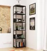 A tall, black metal bookshelf filled with books and decorative items, placed in a room with a brick wall and white walls. Produktbild-Vorschau