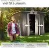 A man is pushing a wheelbarrow next to a garden shed. The shed has its doors open, revealing a lawnmower inside. The image is set outdoors in a grassy area with trees in the background. Náhled obrázku produktu