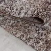 A close-up view of a shaggy rug with a marbled design. Podgląd zdjęcia produktu