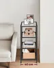 A multi-shelf side table with decorative items on it, placed next to a sofa. Náhled obrázku produktu