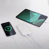 A white power bank is charging a smartphone and a tablet. Náhľad obrázku produktu