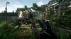 A first-person perspective of a video game scene, showing a player aiming a weapon at a robotic enemy in an overgrown, post-apocalyptic environment. Produktbild-Vorschau