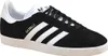A studio shot of a single black Adidas Gazelle sneaker with white stripes and sole. Produktbild-Vorschau