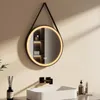 A modern bathroom setting with a round LED mirror above a sink. Produktbild-Vorschau