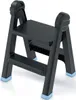 A black folding step stool with blue feet on a white background. Podgląd zdjęcia produktu