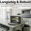 A mini oven on a kitchen counter with food inside. Produktbild-Vorschau