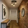 A hallway with a bench, artwork, and a brick wall. Produktbild-Vorschau