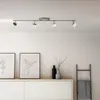 A modern ceiling light fixture with four adjustable spotlights is mounted on a white ceiling above a white cabinet. Produktbild-Vorschau