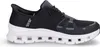 A side view of a black Skechers slip-on sneaker with a white sole. Voir les images du produit