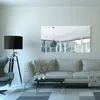 A modern living room with a sofa, a floor lamp, and a mirror on the wall. Produktbild-Vorschau