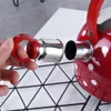 Théière rouge en inox à pois et sifflet Voir les images du produit 8