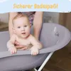A baby is being bathed in a gray baby bathtub with a stand. Produktbild-Vorschau