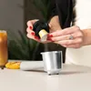 A person is preparing coffee using a coffee capsule and a portafilter. Voir les images du produit