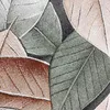 A close-up view of a rug with a leaf pattern. Voir les images du produit