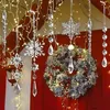 Christmas decorations hanging from a roof, including a wreath, snowflakes, and icicles, with fairy lights. Náhľad obrázku produktu