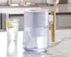 A water pitcher and a glass of water on a kitchen counter. Produktbild-Vorschau