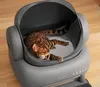 A Bengal cat is sleeping comfortably inside an automatic cat litter box. Anteprima dell’immagine prodotto