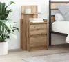 A wooden nightstand with two drawers is placed next to a bed. A large potted plant is on the left side of the nightstand. Náhled obrázku produktu