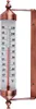 A thermometer with copper accents mounted on a wall bracket. Náhled obrázku produktu
