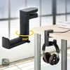 A black headphone stand is clamped to a desk, with headphones hanging from it. Another headphone stand is shown separately, with a rotation graphic indicating 360-degree movement. Produktbild-Vorschau