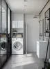 A modern bathroom with a washing machine and storage unit. Náhled obrázku produktu