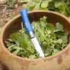 A blue Opinel knife is placed in a wooden bowl filled with green leafy vegetables. Náhled obrázku produktu