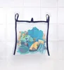 A mesh bag filled with colorful bath toys hangs on a tiled wall, attached by suction cups. Produktbild-Vorschau